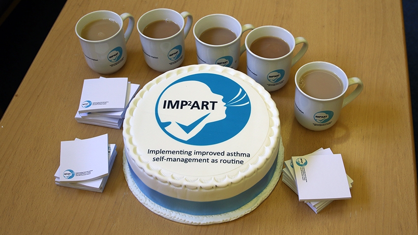 Cake and mugs pictured featuring the IMP2ART logo