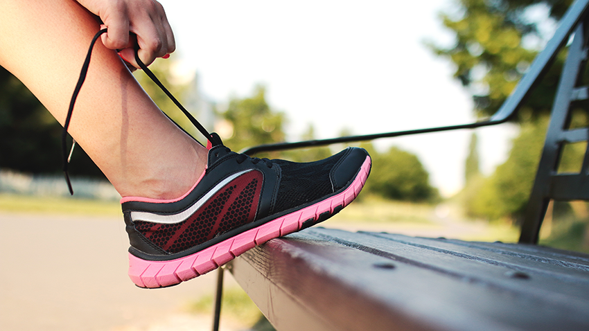 Woman tying laces of trainers