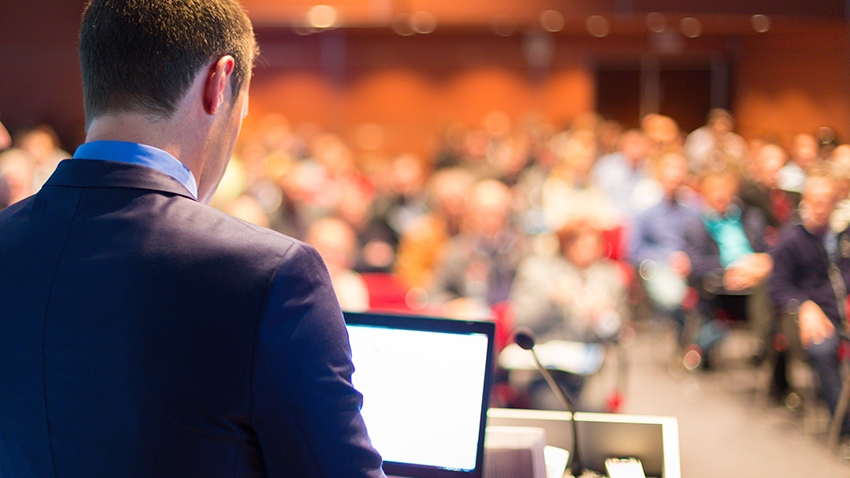 Person speaking in front of audience